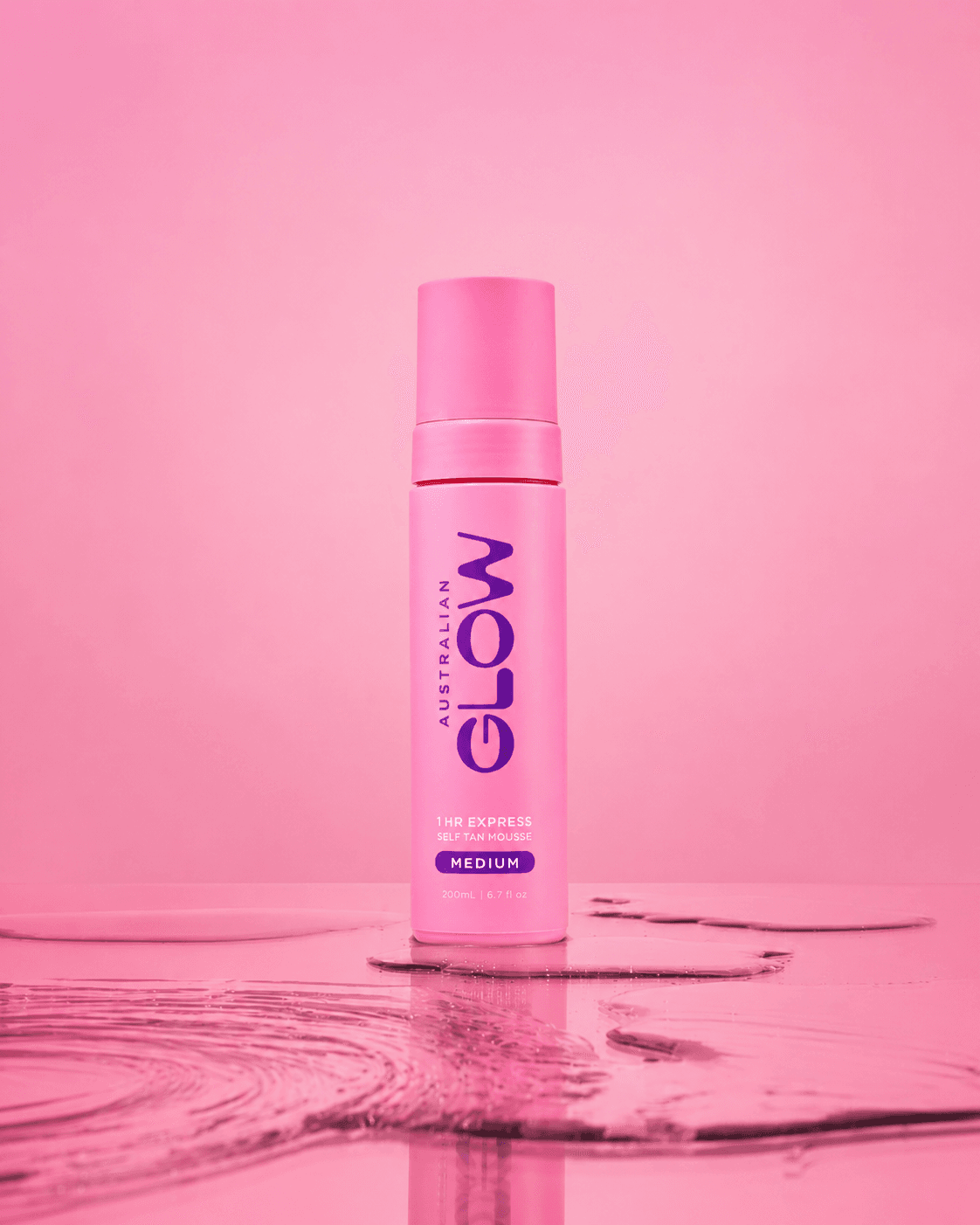 1 Hour Express Mousse — single pink bottle standing in water on a soft pink studio backdrop