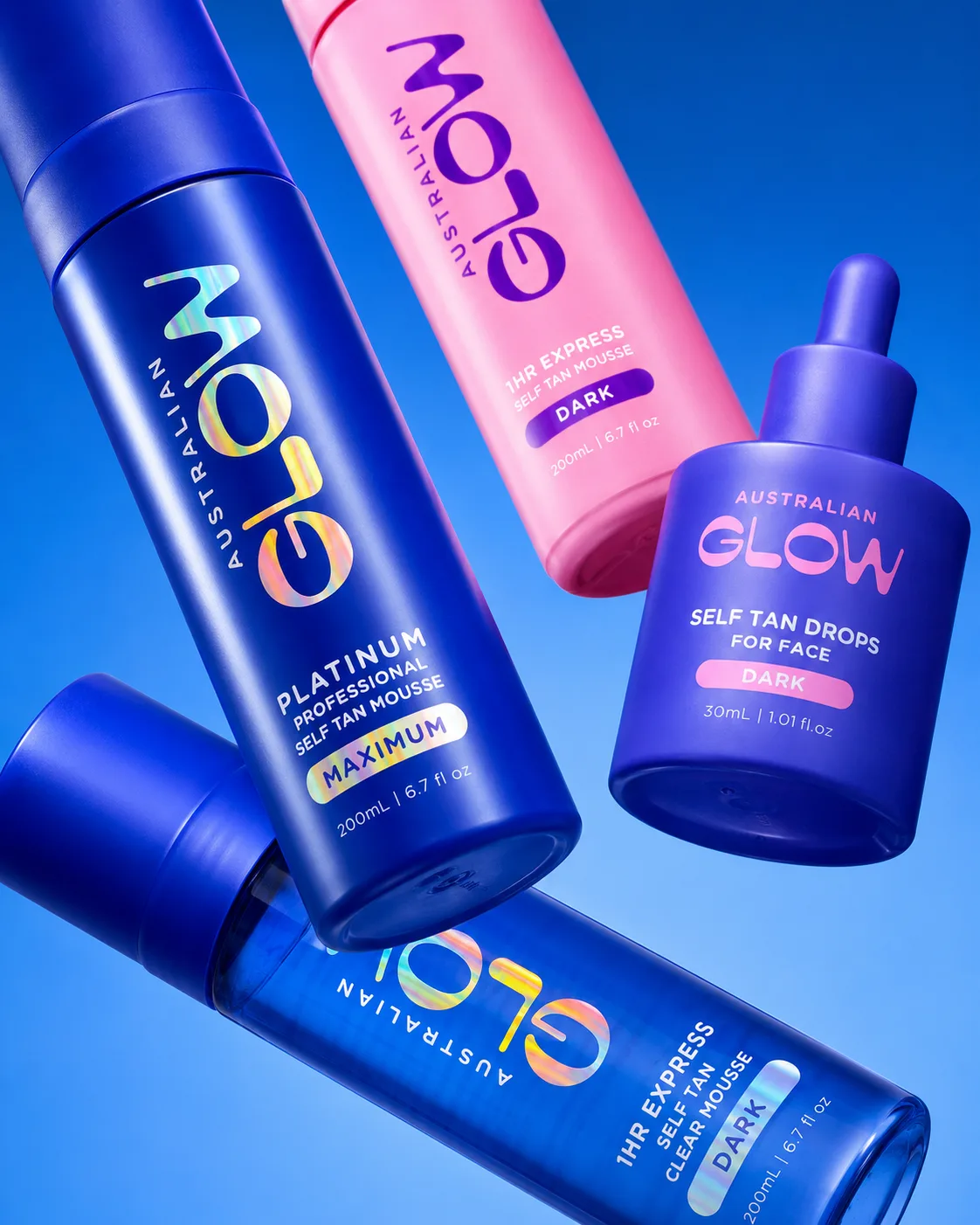 The Australian Glow range floating on electric blue — Platinum, Express Dark, Face Tan Drops and Clear Mousse