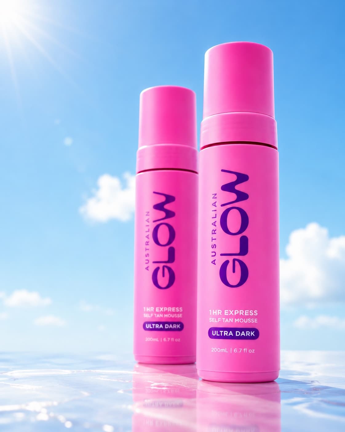 Two pink 1HR Express Ultra Dark mousses on a wet reflective surface under blue sky
